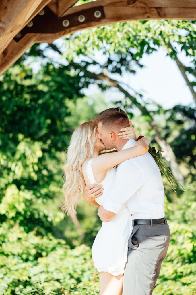 newly engaged couple hugging