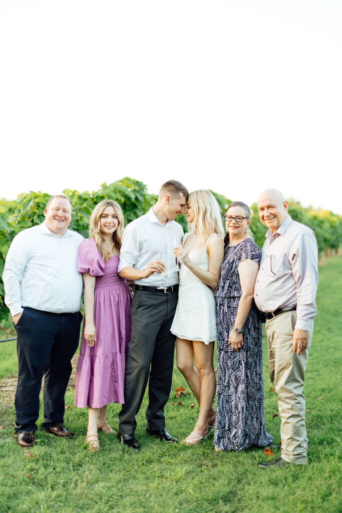 newly engaged couple with their family