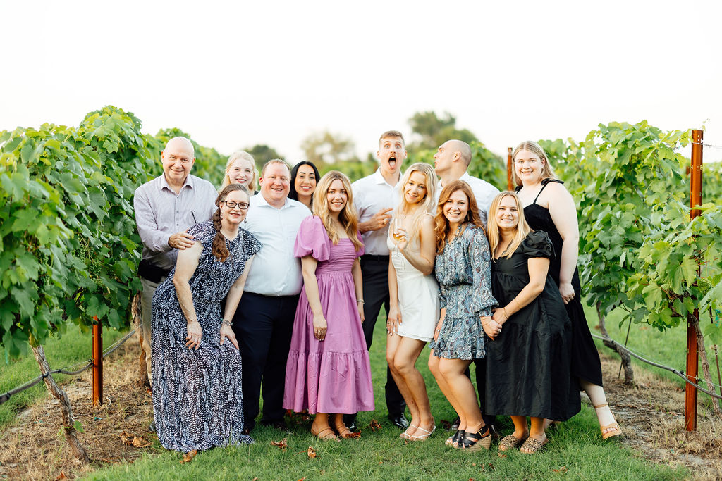 newly engaged couple with their family and friends