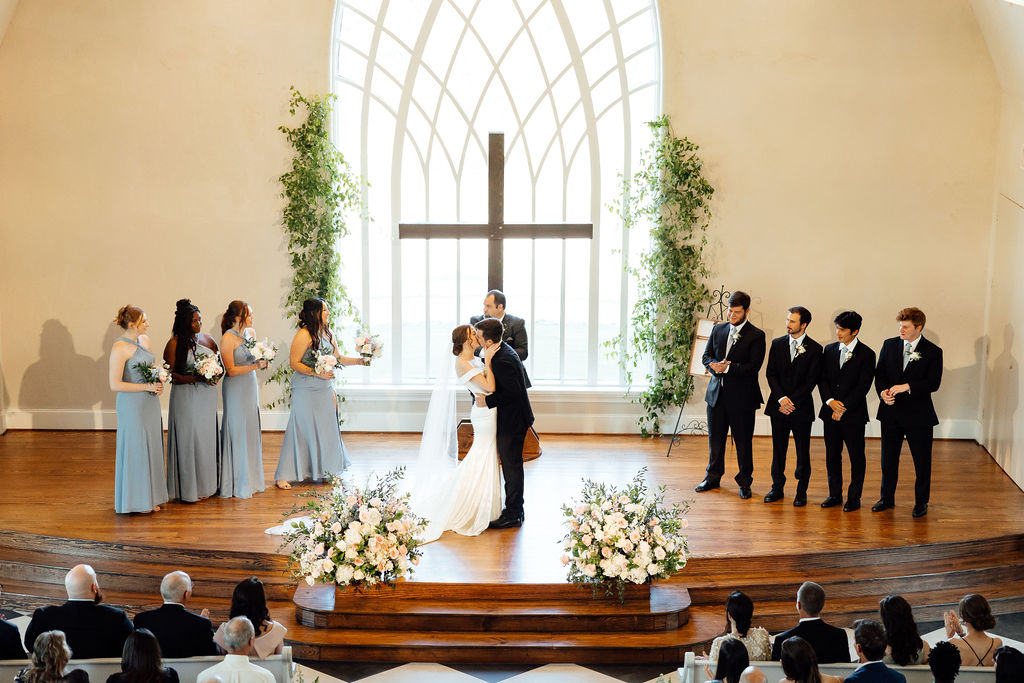 bride and groom kissing after their wedding ceremony 