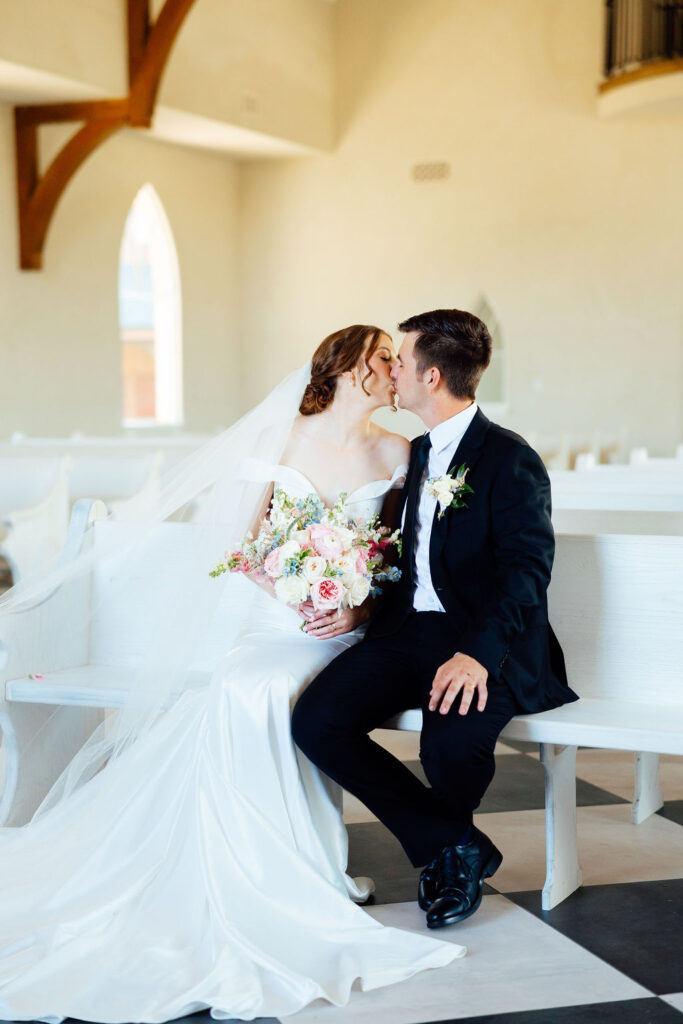 bride and groom kissing after their wedding ceremony