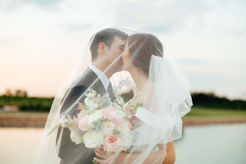 bride and groom kissing at their colorful and fun wedding