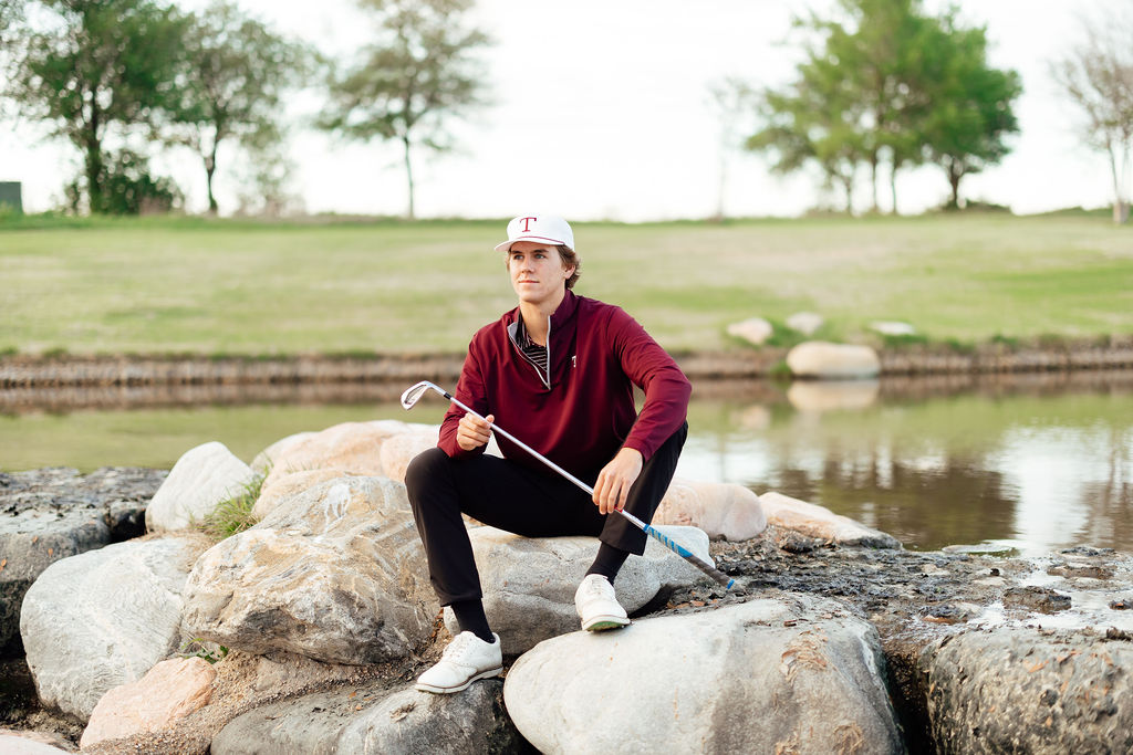 guy sitting on rocks during senior session