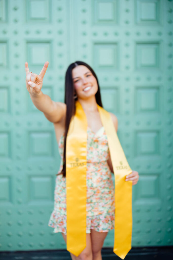 girl taking photos for college graduation in texas