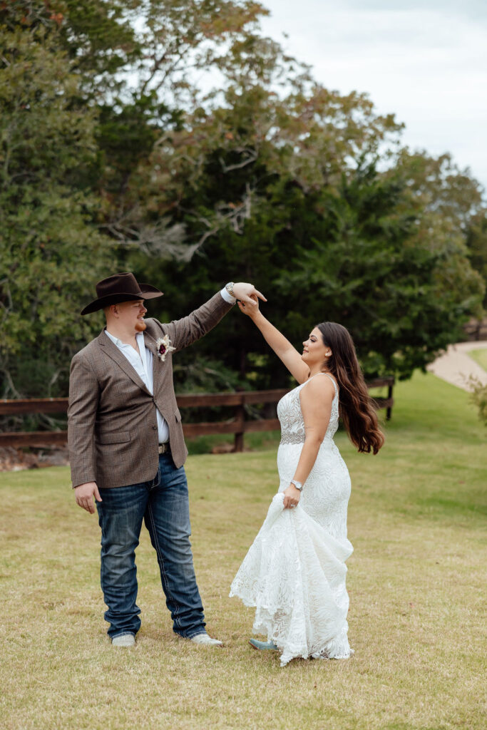 bride and groom dancing in open field