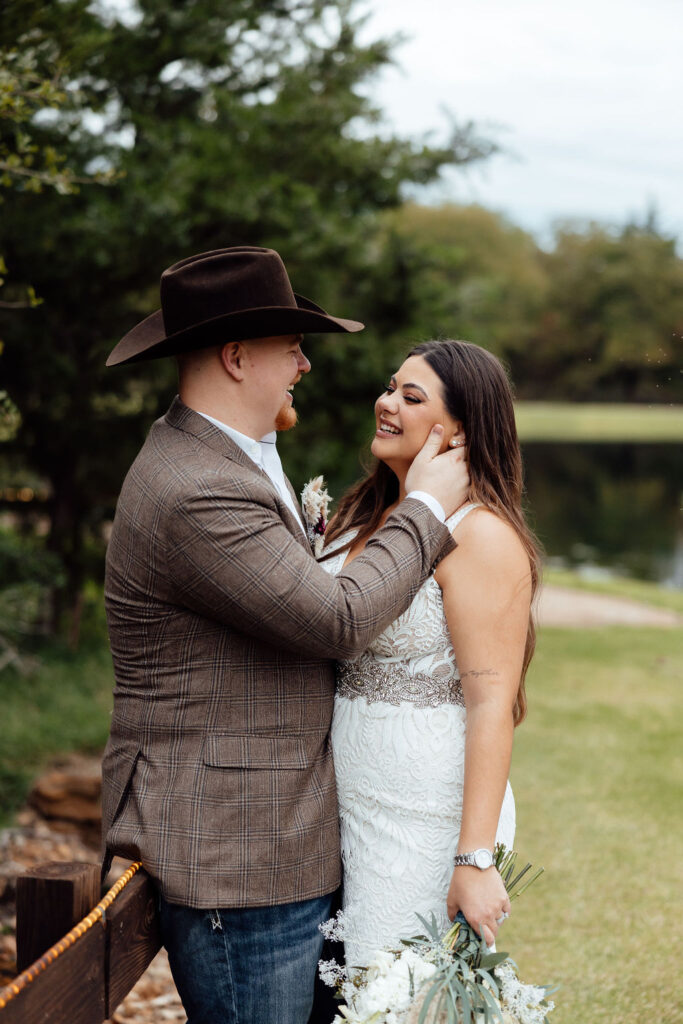 groom holding brides face during portraits 